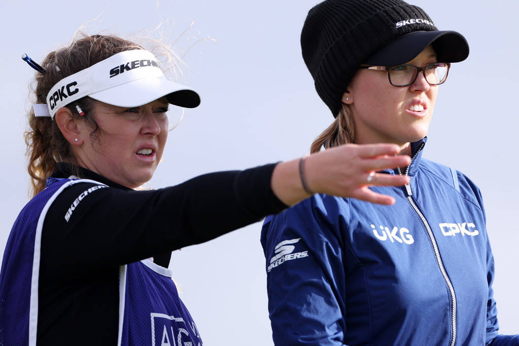 Brooke Henderson (right) in conversation with her caddie